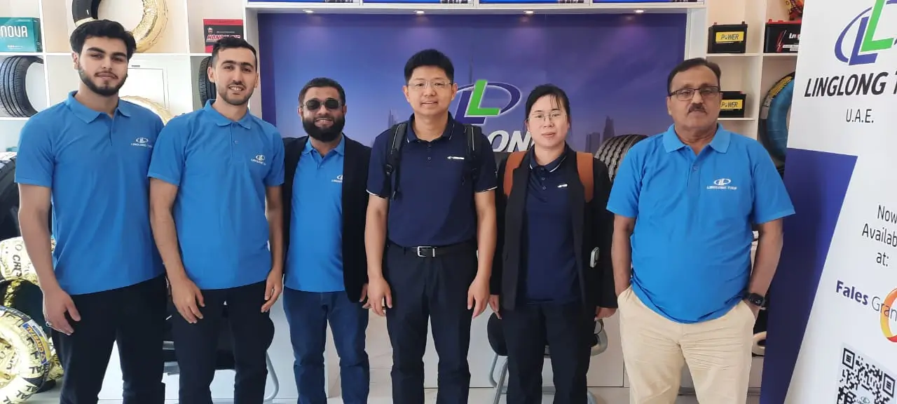 Mr. Aaron, VP of International RE Sales at Linglong Tyre, and Fales Grand executives touring a UAE showroom during his April 2025 visit.