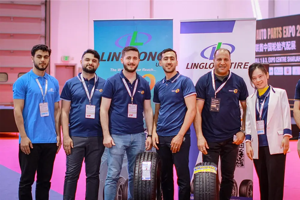 Fales Grand team poses in front of the UAE China Tyre & Auto Parts Expo 2025 backdrop at Expo Centre Sharjah.