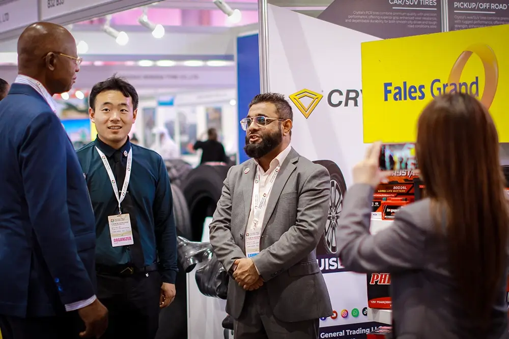 Fales Grand team poses in front of the UAE China Tyre & Auto Parts Expo 2025 backdrop at Expo Centre Sharjah.